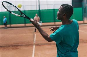 Man Serving Tennis Ball